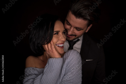 Beautiful young couple looking at each other in the studio