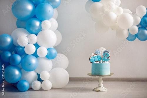 blue cake on children's birthday with the number two and the car
