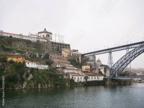 Cityscape of Porto, Portugal on a rainy day in spring with Dom Luis bridge on right