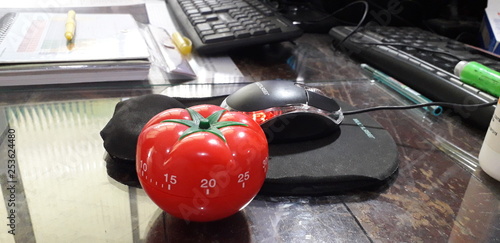 Pomodoro timer - mechanical tomato shaped kitchen timer for cooking or studying. photo