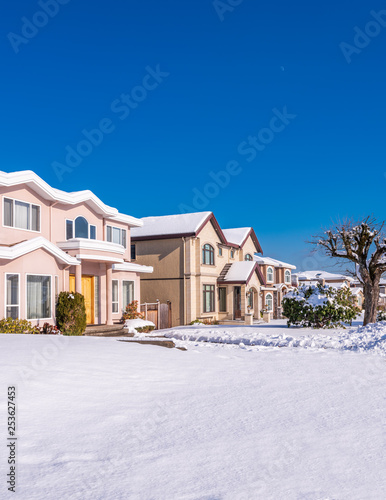 Houses in suburb at Winter in the north America. Luxury houses covered nice snow.
