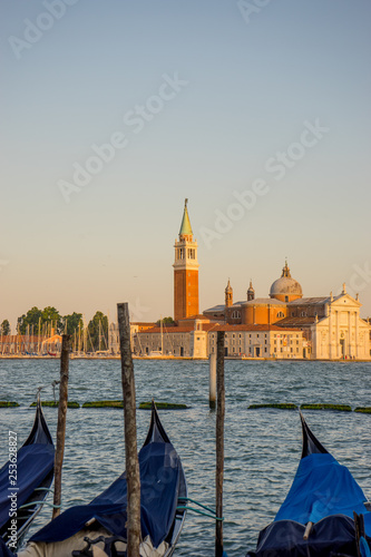 Gondolas moored by Saint Mark square with San Giorgio di Maggiore church in the background in Venice, Italy