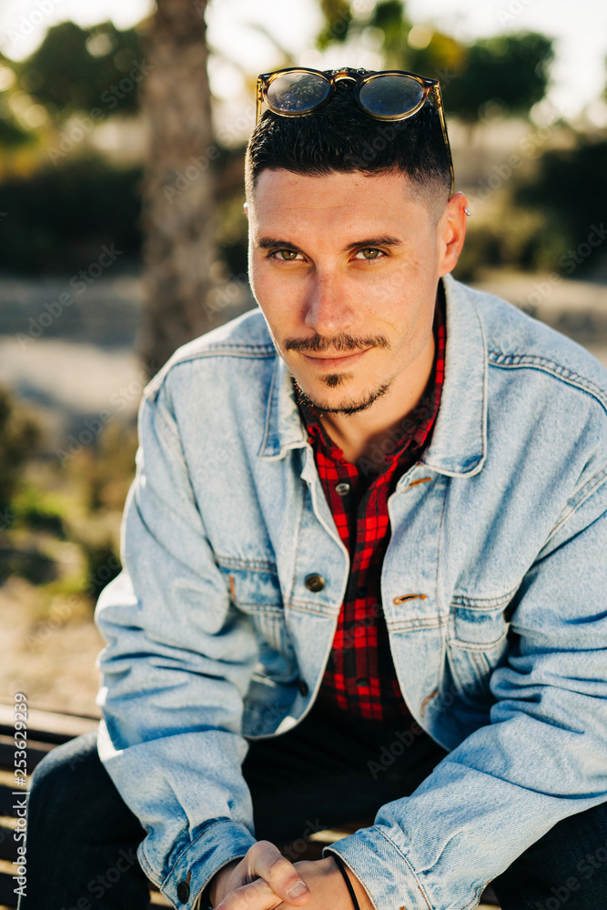 Attractive young man with sunglasses and denim jacket Attractive young man with sunglasses and denim jacket