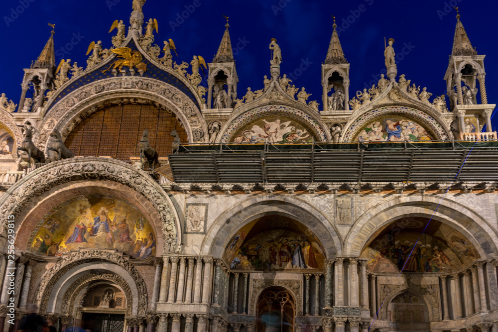 Italy, Venice, St Mark's Basilica at night, a church with a clock on the front of St Mark's Basilica