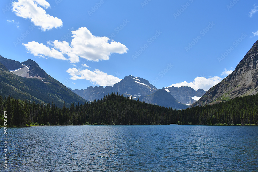Mountains and Pine Trees Surrounding a Bright Blue Lake in Glacier National Park, Montana