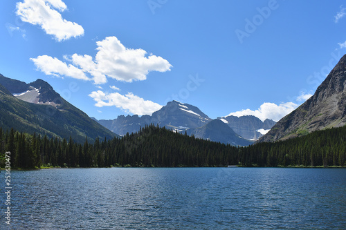 Mountains and Pine Trees Surrounding a Bright Blue Lake in Glacier National Park, Montana