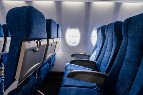 Interior view of economy coach seats inside of passenger airplane