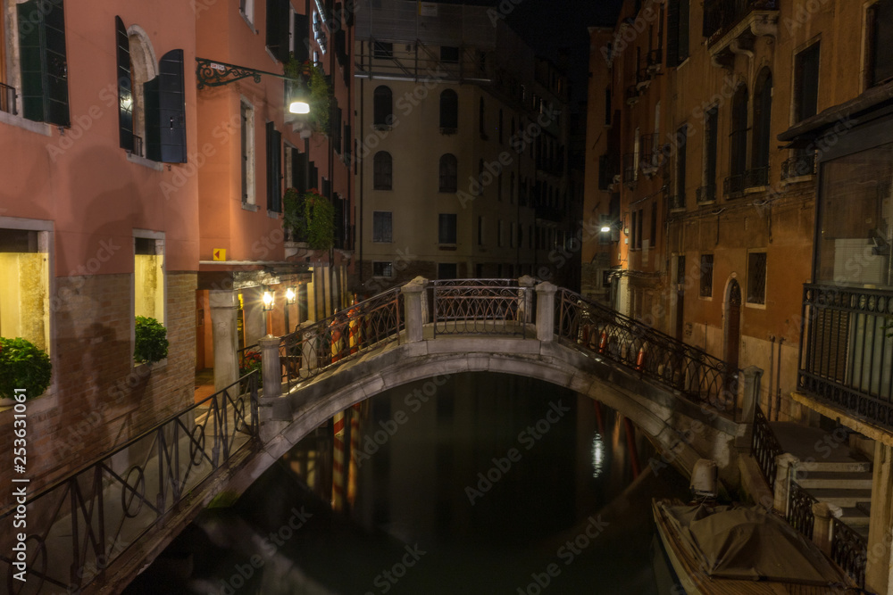 Italy, Venice, a long bridge over a canal in a city at night