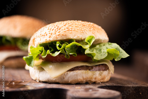 Homemade burger on wooden background.