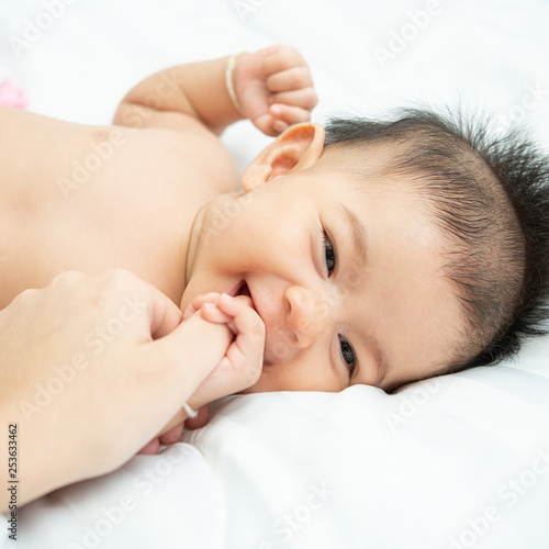 baby relax in a white bedroom. Family with children at home. Love, trust and tenderness.Concept of love and family