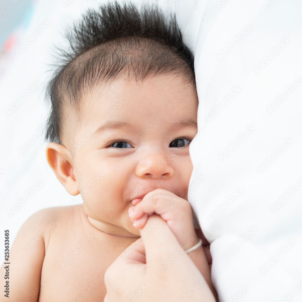 baby relax in a white bedroom. Family with children at home. Love, trust and tenderness.Concept of love and family baby relax in a white bedroom. Family with children at home. Love, trust and tenderness.Concept of love and family