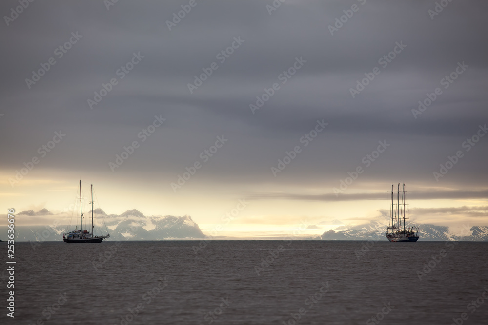 ships in the bay fjord of Longyearbyen Svablbard of Norway at sunset ships in the bay fjord of Longyearbyen Svablbard of Norway at sunset