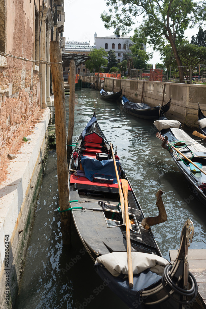 The gondolas parked along the canal in Venice, Italy