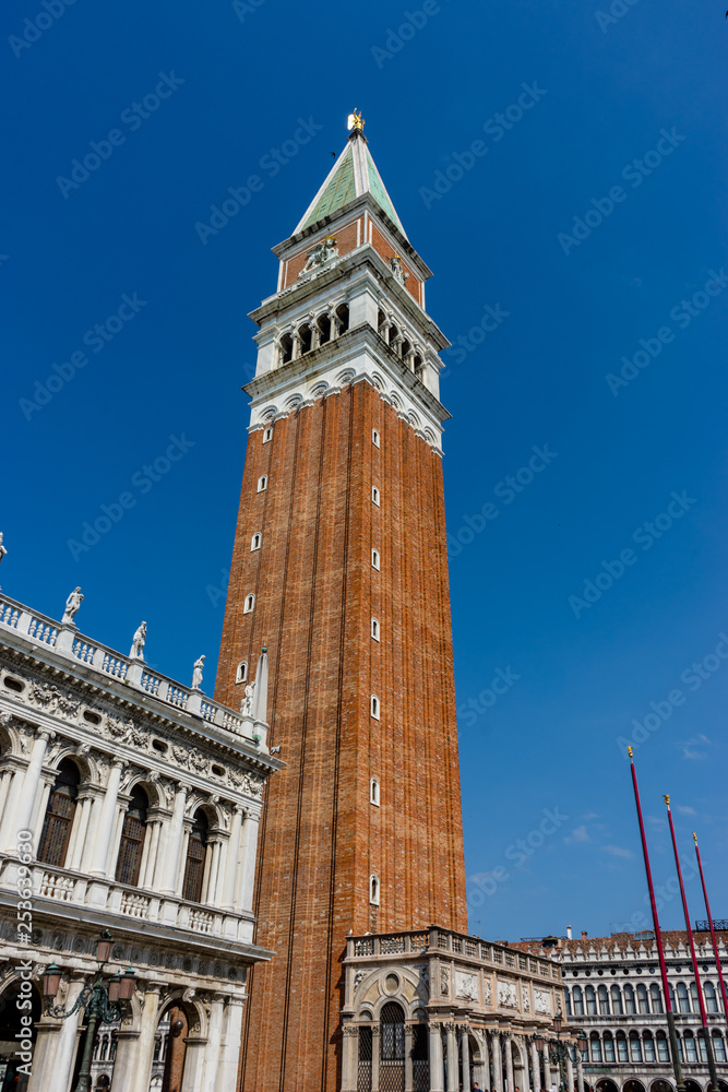 Italy, Venice, St Mark's Campanile, a large tall tower with a clock on the side of St Mark's Campanile