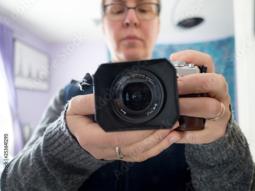 woman taking photographs indoors