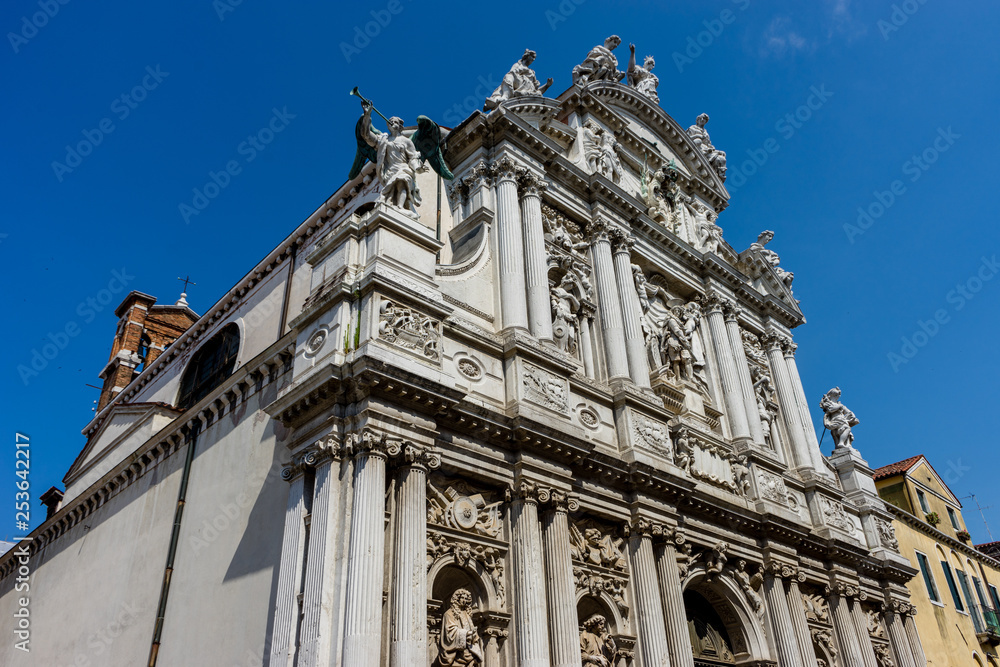 Italy, Venice, a large tall tower with a clock on the side of a building