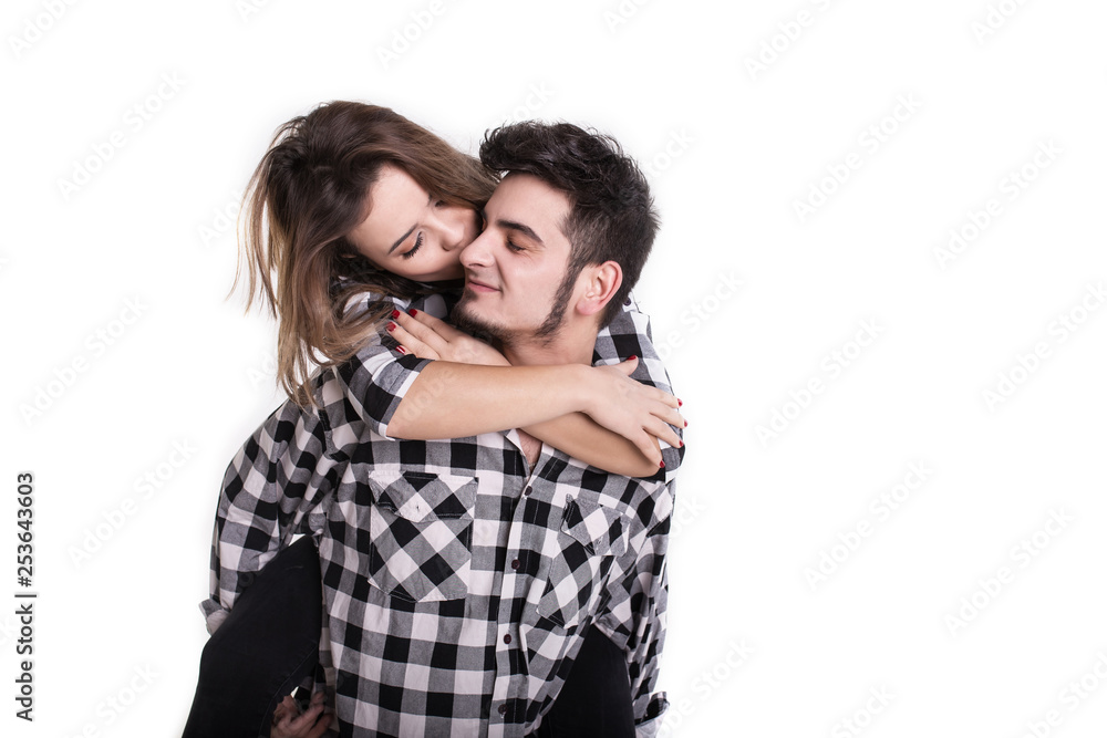 Happy young couple embracing each other and kissing isolated on white Happy young couple embracing each other and kissing isolated on white