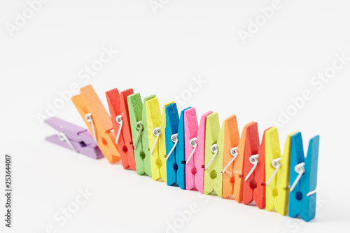 Colorful wooden clothespins on white background