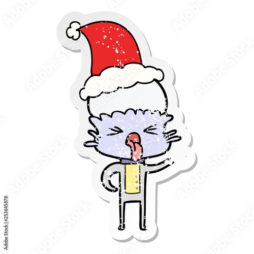 disgusted distressed sticker cartoon of a alien wearing santa hat