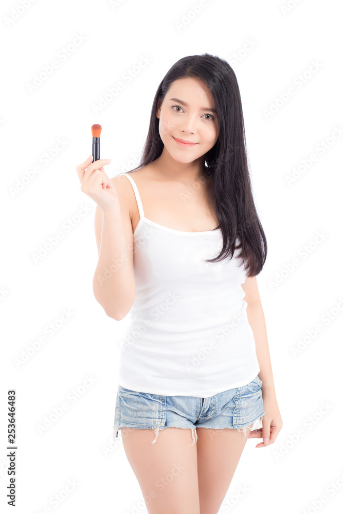 Beauty of portrait asian woman applying make up with brush of cheek isolated on white background, beautiful of girl holding blusher, skincare and cosmetic concept.