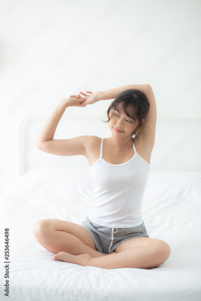 Beautiful of portrait young asian woman stretch and relax in bed after wake up morning at bedroom, new day and resting for health and wellness, back view, lifestyle concept. Beautiful of portrait young asian woman stretch and relax in bed after wake up morning at bedroom, new day and resting for health and wellness, back view, lifestyle concept.