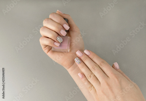 Stylish fashionable women pink manicure with nail polish