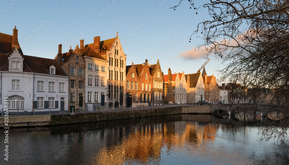 Brugge evening cityscape. Old buildings at water channel in Bruges, Belgium