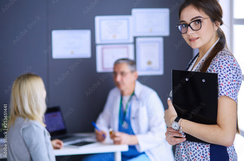 Doctor and patient discussing something while sitting at the table . Medicine and health care concept Doctor and patient discussing something while sitting at the table . Medicine and health care concept