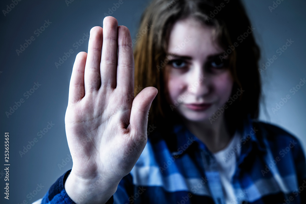 Beautiful red hair young stressed woman showing stop hand sign gesture. Violence concept. Beautiful red hair young stressed woman showing stop hand sign gesture. Violence concept.