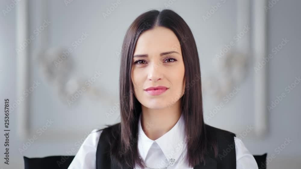 Medium close-up portrait of Caucasian confident pretty businesswoman looking at camera Medium close-up portrait of Caucasian confident pretty businesswoman looking at camera