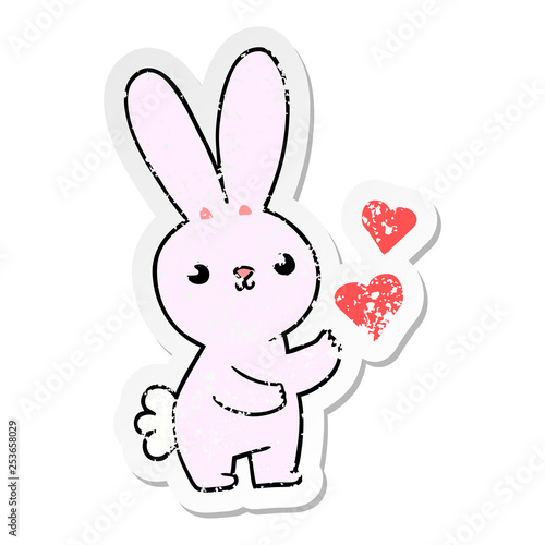 distressed sticker of a cute cartoon rabbit with love hearts
