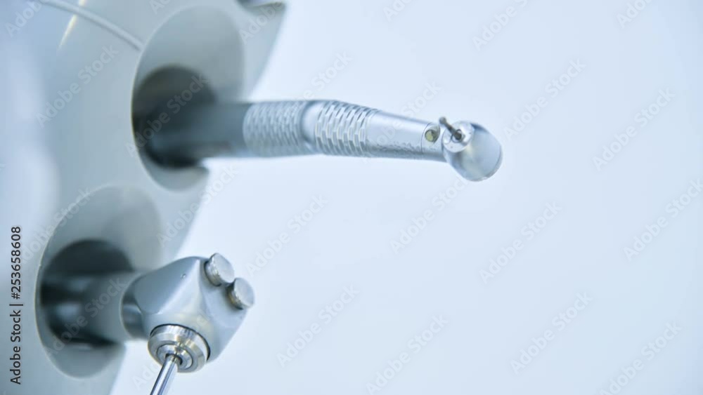 Close-up set of professional tools in the dentist's office on the holder. High key. Stamotology concept Close-up set of professional tools in the dentist's office on the holder. High key. Stamotology concept