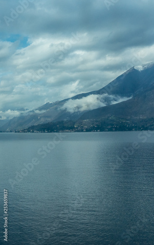 Italy, Varenna, Lake Como, a large body of water with a mountain in the background