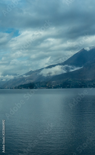 Italy  Varenna  Lake Como  a large body of water with a mountain in the background