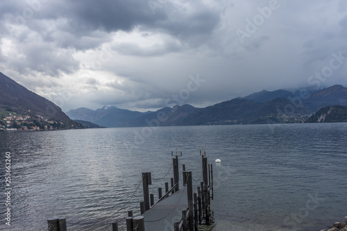 Italy, Varenna, Lake Como, a large body of water with a mountain in the background
