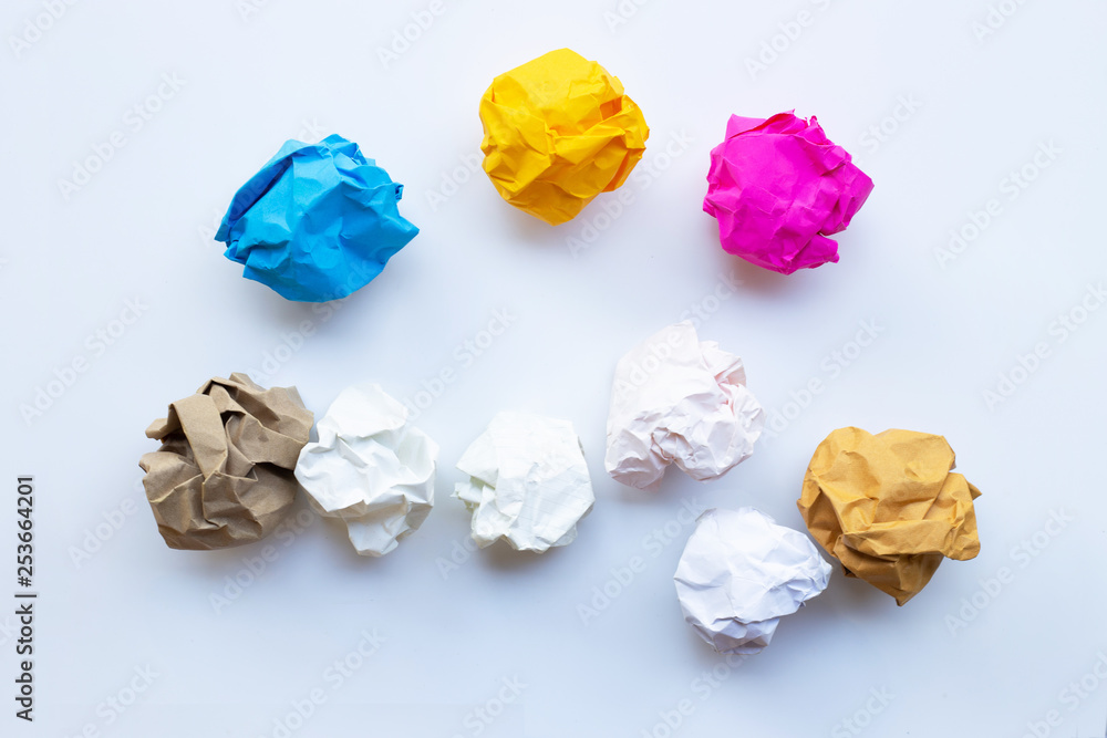 Colorful alarm clock ring with yellow crumpled paper ball isolated on white Colorful alarm clock ring with yellow crumpled paper ball isolated on white