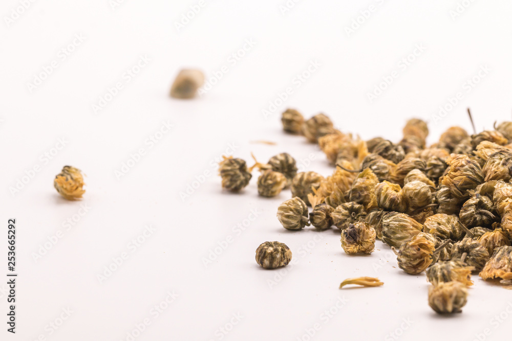 Dried Chrysanthemum petal flower on isolate white background.Blurred close up Chrysanthemum flower buds and tea on white background. Dried Chrysanthemum petal flower on isolate white background.Blurred close up Chrysanthemum flower buds and tea on white background.