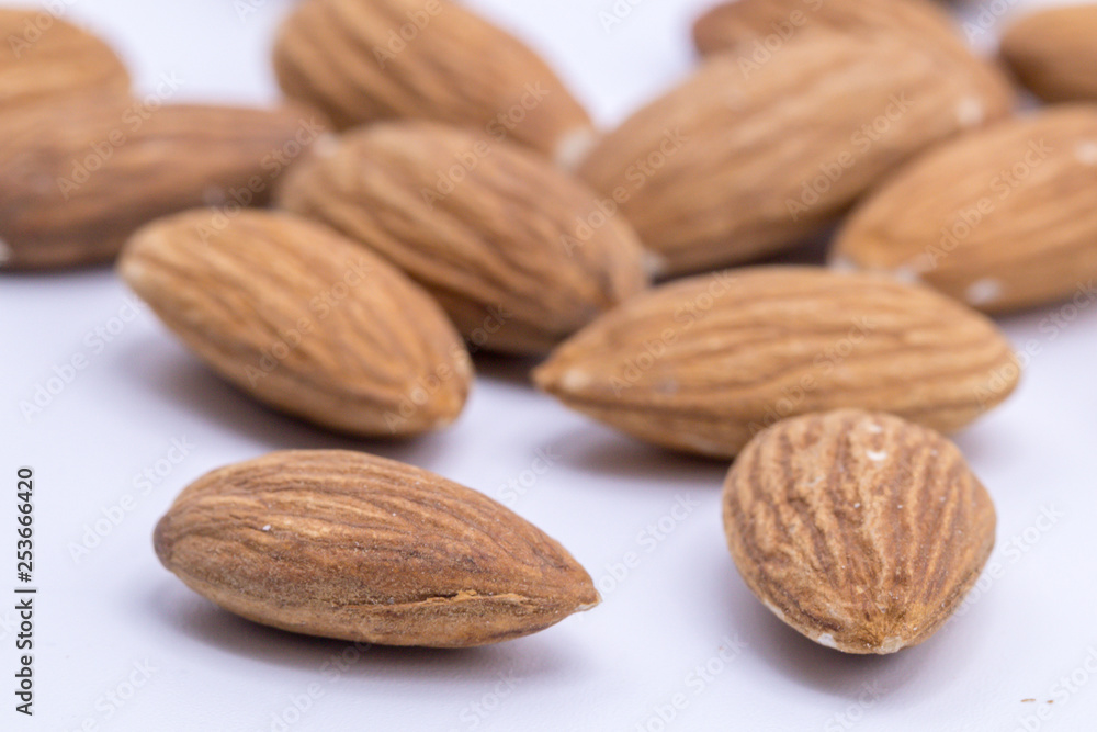 Raw natural organic close up Almonds on isolate white background.Close up Almond seeds. Raw natural organic close up Almonds on isolate white background.Close up Almond seeds.