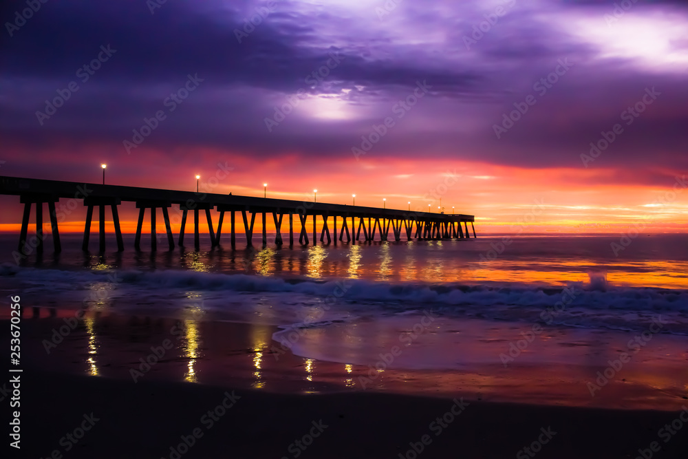 Atlantic Ocean sunrise with pier and full moon