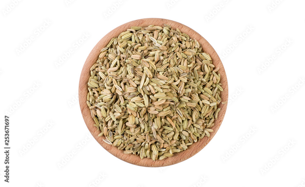 fennel seeds in wooden bowl isolated on white background. Spices and food ingredients.