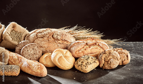Fotografija Fresh bread assortment on dark surface