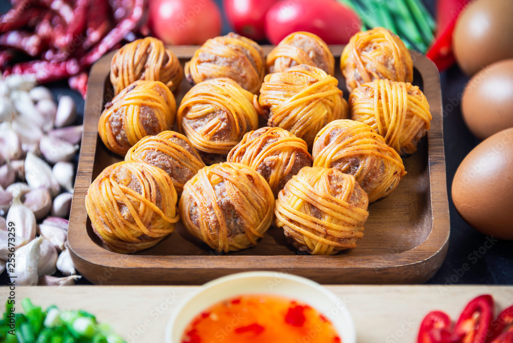 Deep Fried Wrapped Pork with Chinese Noodle Traditional Thai food.Thai traditional snacks menu ( Thai name is Moo sarong) Deep Fried Wrapped Pork with Chinese Noodle Traditional Thai food.Thai traditional snacks menu ( Thai name is Moo sarong)