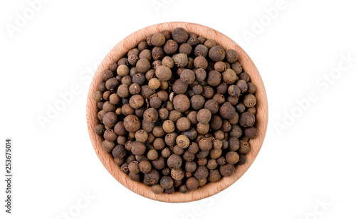 allspice in wooden bowl isolated on white background. Spices and food ingredients.
