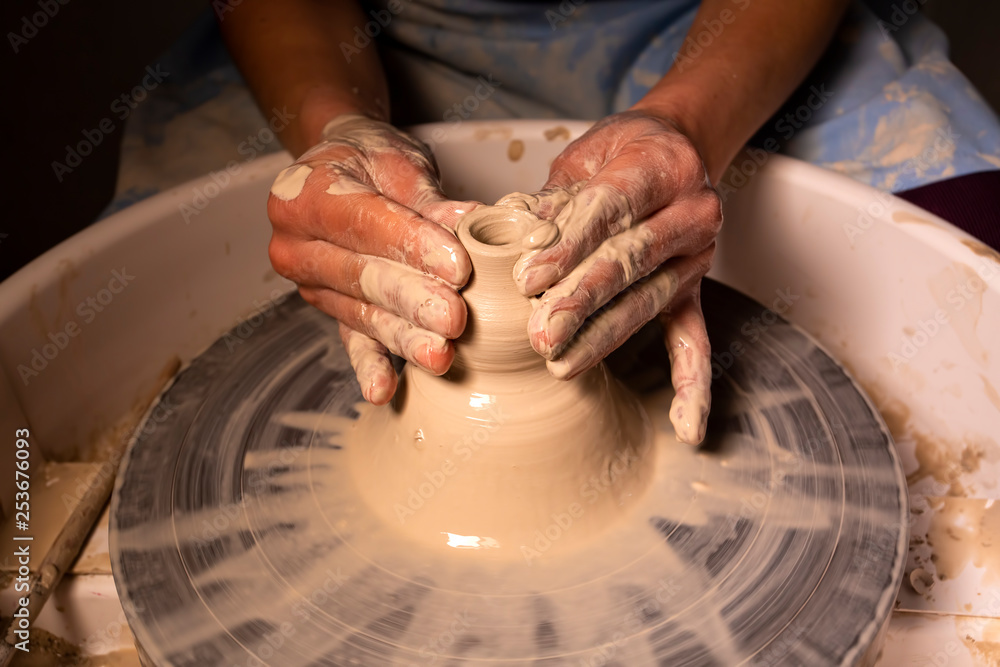 Professional potter making bowl in pottery workshop Professional potter making bowl in pottery workshop