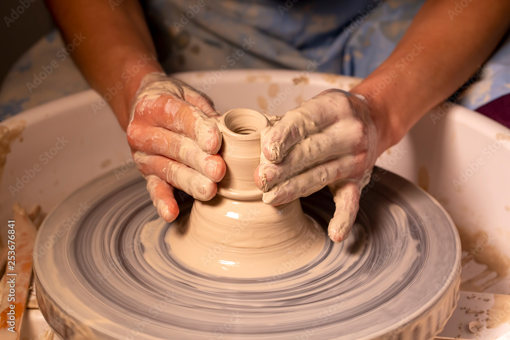 Professional potter making bowl in pottery workshop Professional potter making bowl in pottery workshop