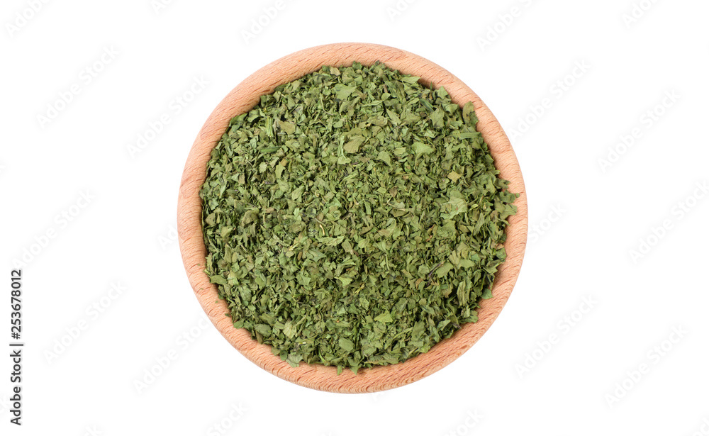 coriander leaves in wooden bowl isolated on white background. Spices and food ingredients. coriander leaves in wooden bowl isolated on white background. Spices and food ingredients.
