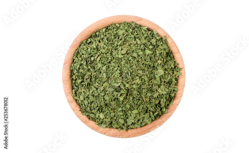 coriander leaves in wooden bowl isolated on white background. Spices and food ingredients.