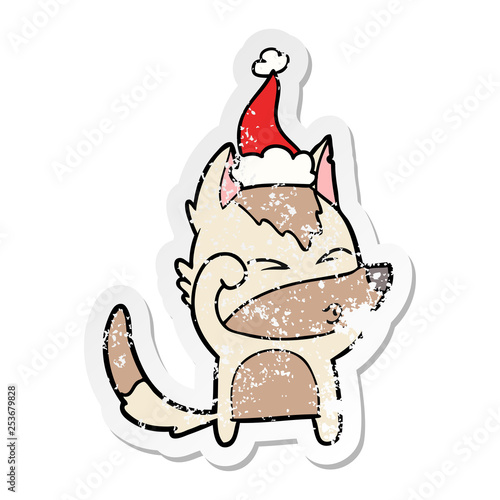 distressed sticker cartoon of a wolf pouting wearing santa hat