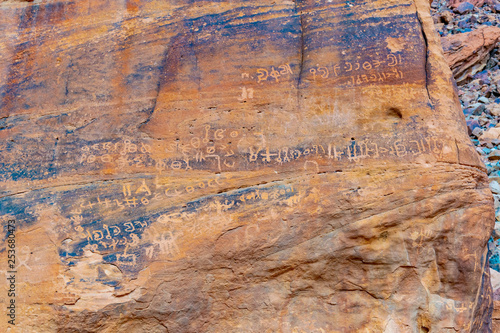 Ancient inscriptions at Lawrence spring at Wadi Rum desert in jordan photo