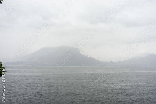 Italy, Varenna, Lake Como, a large body of water with a mountain in the background